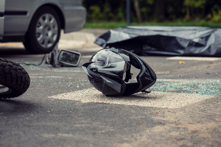 Black motorcycle helmet on the street after collision with a car - Orlando Motorcycle Accident Lawyer