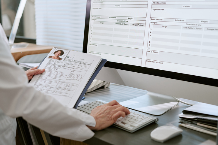 Doctor reviewing patient records - How do pre-existing conditions affect a personal injury case?