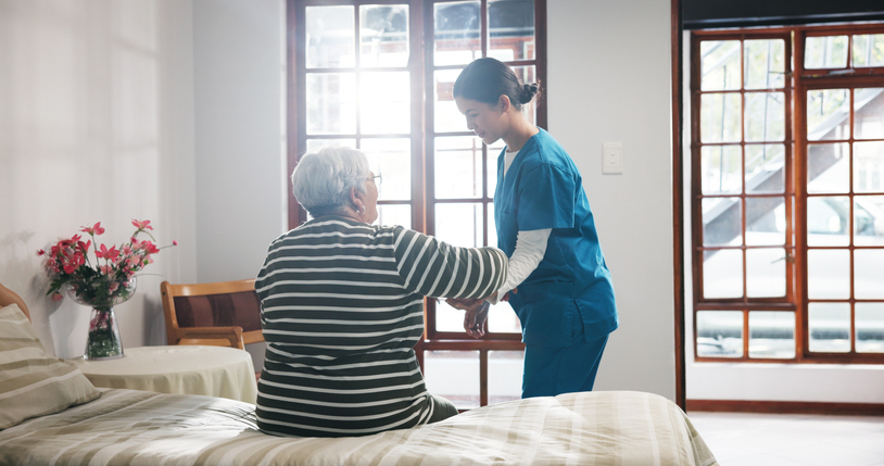 Senior patient recieving help from a caregiver at a nursing home - Orlando nursing home abuse lawyer